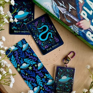 May include: A set of four illustrated cards with a blue, green, and black color scheme. The cards feature a snake, a spaceship, and a leafy pattern. The cards are part of a larger set of cards with the text "ICE PLANET BARBARIANS" on the box.