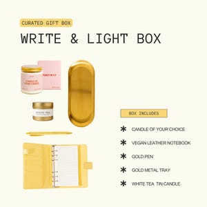 a curated gift box containing various items such as a candle, a notebook, a pen, a tin candle, and a gold pen.