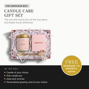 a gift set consisting of a candle, a candle care box, and a personalized greeting card. The candle care box contains a candle, a candle care box, and a candle wick trimmer. The gift set is presented in a pink box with white paper, and there is a free upgrade offer for priority shipping.