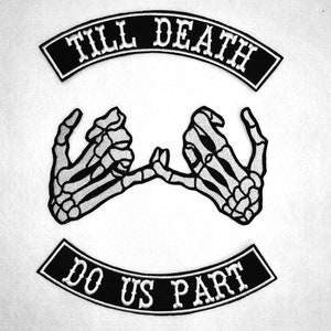 May include: Black and white embroidered patch with two skeleton hands holding pinkies together. The patch has the text "Till Death Do Us Part" in a black banner.