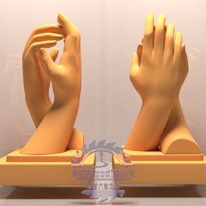 May include: Two hands clasped together, sculpted in a light orange colour, are displayed on a wooden base. The sculpture is set against a white background.