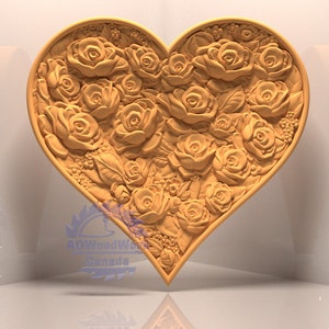 May include: A heart-shaped wooden carving with a detailed design of roses and leaves. The carving is a light brown color and has a smooth, polished finish.