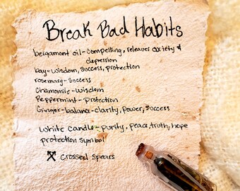 May include: A handwritten list of herbs and their properties for breaking bad habits, with a small glass bottle filled with herbs and a protection symbol. The list includes bergamot oil, bay, rosemary, chamomile, peppermint, ginger, and a white candle. The text reads "Break Bad Habits" and "Keep in home or on person to help encourage breaking bad habits."