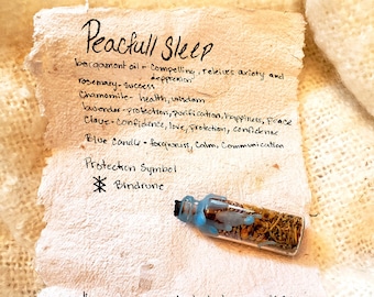 May include: A small glass bottle with a blue lid filled with dried herbs and a handwritten note listing the herbs and their properties for peaceful sleep. The note says "Peactull Sleep" and lists the herbs and their properties. The note also says "Keep in home on bedside to encourage a peacfull night Sleep."