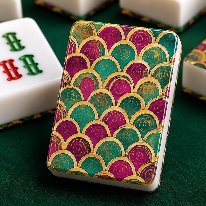 May include: A rectangular mahjong tile featuring a vibrant pattern of overlapping semicircles in shades of magenta, teal, and gold. The tile has a smooth, glossy finish with rounded edges, showcasing a repeating scale-like design on its back.