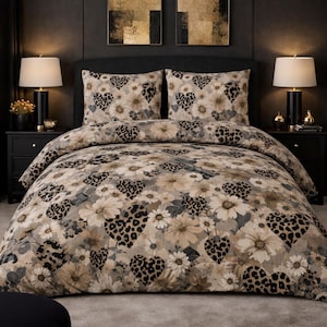 May include: A bed set featuring a floral pattern with heart-shaped leopard print accents. The bedding includes a duvet cover and two pillowcases. The color palette consists of neutral tones, including beige, gray, and black.