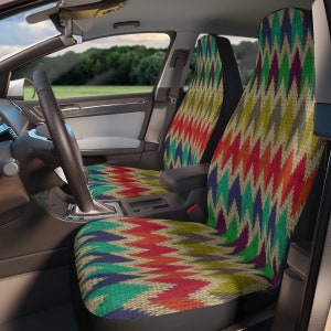 May include: Two colorful car seat covers with a geometric pattern in shades of red, orange, yellow, green, blue, and purple. The covers are made of a woven fabric with a textured surface.