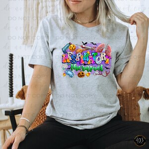 May include: A gray t-shirt with a colorful graphic design that says "Respiratory Therapist" with Halloween-themed imagery, including pumpkins, bats, and medical equipment.