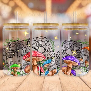May include: Three clear glass tumblers with bamboo lids and straws. Each tumbler features a colorful mushroom design with black outlines and a sparkling effect.