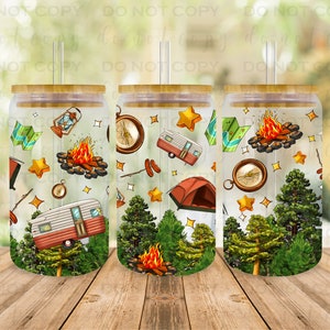 May include: Three clear tumblers with a bamboo lid and a straw. The tumblers are decorated with a camping theme, featuring a vintage camper, a campfire, a compass, a lantern, and pine trees. The background is a light yellow with white stars.