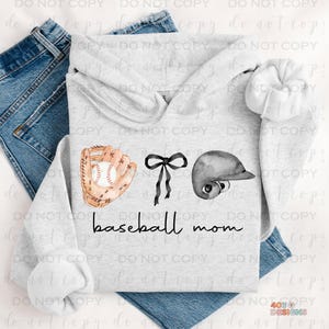 May include: A gray hoodie with a watercolor illustration of a baseball glove, baseball, bow, and helmet. The text "baseball mom" is printed in black below the illustration.