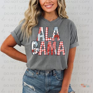 May include: A gray V-neck t-shirt with the word "ALABAMA" in a patchwork design. The letters feature red and white gingham, floral, and blue patterns. The shirt is paired with denim shorts.