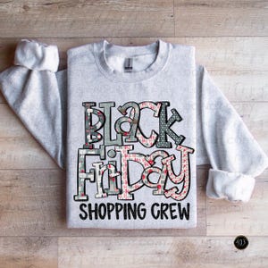 May include: A gray sweatshirt with a black and red design that says "Black Friday Shopping Crew".