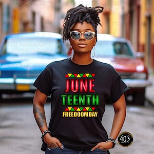 May include: Black t-shirt with the words "JUNE TEENTH FREEDOOMDAY" in red and green, with a colorful triangle design above and below the text. The shirt is worn by a person wearing sunglasses and hoop earrings.