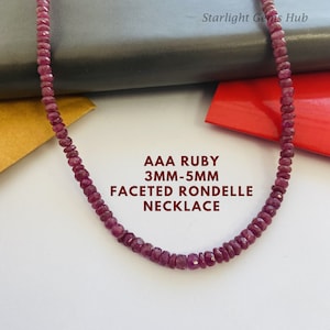 May include: A necklace made of ruby red faceted rondelles. The necklace is made of AAA quality ruby beads that are 3mm to 5mm in size. The text "AAA RUBY 3MM-5MM FACETED RONDELLA NECKLACE" is displayed below the necklace.