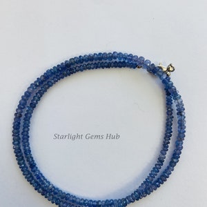 May include: A double strand necklace made of blue gemstone beads. The necklace has a silver clasp.