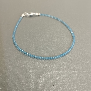 Puede incluir: Un delicado brazalete de piedras azules con cierre de plata.