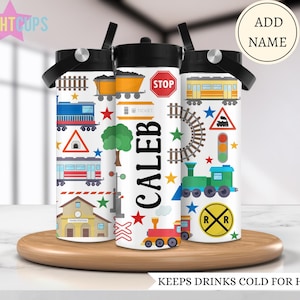 May include: Three white stainless steel water bottles with a train theme. The bottles have a black lid and a straw. The middle bottle has the name "Caleb" printed on it. The bottles are on a wooden surface.