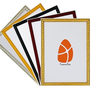 May include: A selection of picture frames with different coloured borders, including silver, gold, black, and burgundy. Each frame has a white interior with an orange egg-shaped graphic and the text "FramesDen".