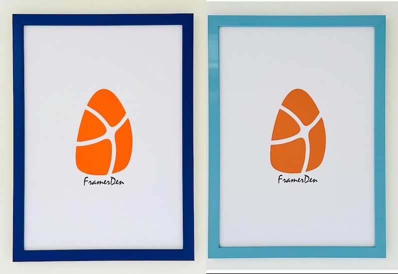 May include: Two framed art prints. One has a navy blue frame, the other a light blue frame. Each features an orange egg-shaped design with white lines and the text "FramesDen" in black script.