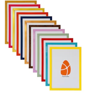 May include: A set of 12 colourful picture frames in various colours, including yellow, orange, red, pink, blue, green, and brown. The frames are arranged in a cascading pattern, with the largest frame at the top and the smallest frame at the bottom. The frames are all made of wood and have a simple, modern design. The smallest frame has a white background with an orange egg-shaped design and the text "FramerDen".