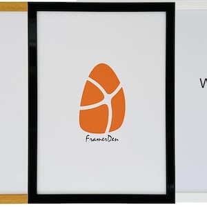 May include: Three picture frames in oak, black, and white. The center frame has a white background with an orange abstract design and the text "FramesDen". The other two frames are empty.