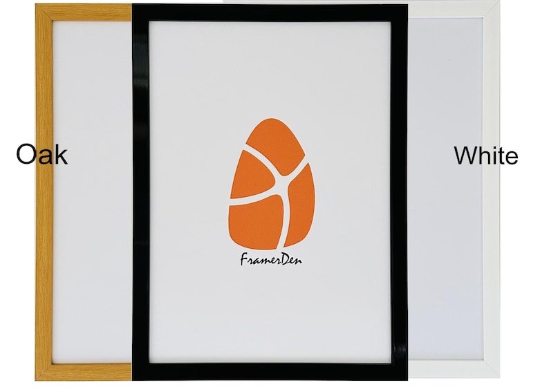 May include: Three picture frames in oak, black, and white. The center frame has a white background with an orange abstract design and the text "FramesDen". The other two frames are empty.