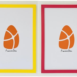 May include: Two framed art prints. One frame is yellow, the other is red. Each frame contains a white background with an orange egg-shaped design. The text "FramesDen" is printed in black at the bottom of each print.