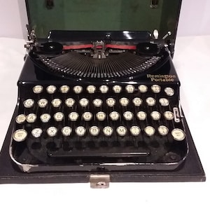 Remington Portable early 1931 portable, working, manual typewriter, cast metal body in case new ribbon, excellent working order.
