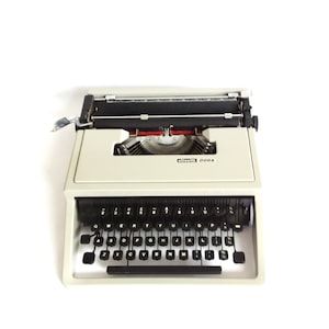 Olivetti Dora vintage typewriter, 1971, grey/green portable QWERTY typewriter. Blue case.