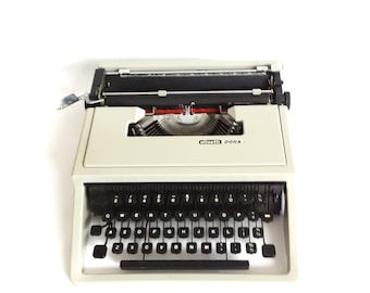 Olivetti Dora vintage typewriter, 1971, grey/green portable QWERTY typewriter. Blue case.