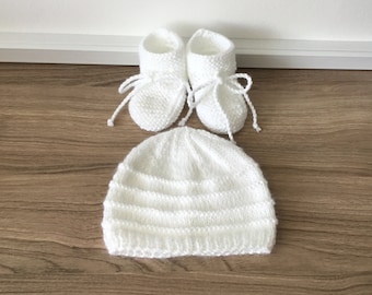 Hand-knitted white baby slippers and hat