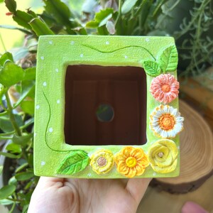 Handmade and hand painted succulent planter pot with Flower vines and flower shapes