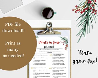 May include: A printable Christmas game sheet titled What's in your phone? featuring a checklist of holiday-themed tasks with point values. The paper is secured on a wooden clipboard and decorated with watercolor pine branches and red berries.