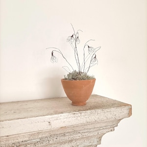 Handmade wire snowdrops in handmade rustic terracotta pot