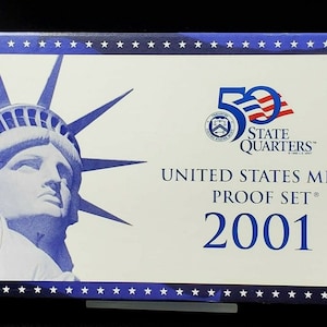 May include: A white box with a blue border and a blue image of the Statue of Liberty. The box has the text "50 State Quarters", "United States Mint Proof Set", and "2001" printed on it.