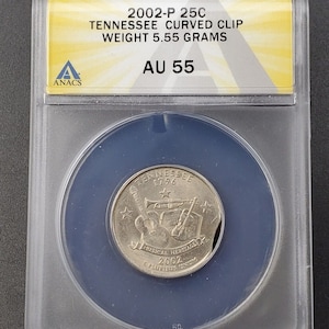 May include: A silver 2002-P Tennessee quarter dollar coin in a blue and clear plastic coin holder. The coin features a musical heritage design with a trumpet, guitar, violin, and a star. The coin is graded AU 55 by ANACS.