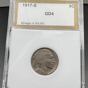 May include: A 1917-S Buffalo nickel graded GD4 in a plastic slab. The label indicates a mintage of 4,193,000.
