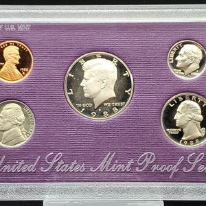 May include: A United States Mint Proof Set from 1988, packaged by the U.S. Mint. The set includes a penny, nickel, dime, quarter, and half-dollar coin.