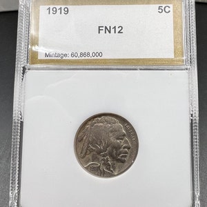 May include: A 1919 Buffalo nickel graded FN12 in a plastic coin holder. The holder has a label with the year, grade, and mintage: 60,868,000.