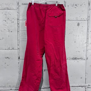 May include: A pair of red drawstring trousers with a single back pocket and elastic cuffs.