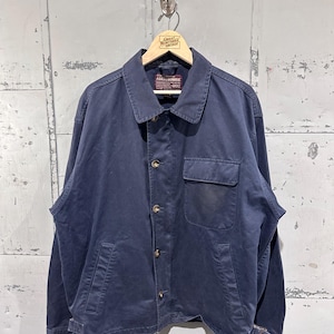 May include: A navy blue Abercrombie jacket with a button-up front, two front pockets, and a collar. The jacket is hanging on a wooden hanger. The Abercrombie label is visible. The jacket has a vintage look.