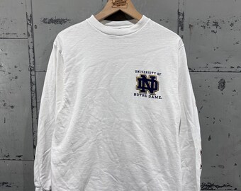 Camiseta vintage de fútbol americano universitario de la Universidad de Notre Dame de los años 90, manga larga, blanca, con gráficos, talla pequeña