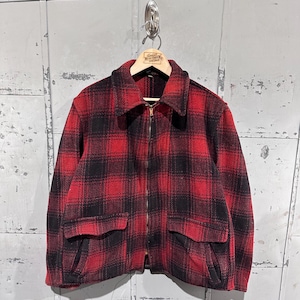 May include: A red and black plaid jacket with a zipper closure and two front pockets. The jacket is hanging on a wooden hanger. The jacket is made of a thick, warm material, perfect for cold weather.