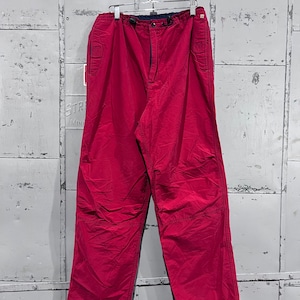 May include: A pair of pink casual trousers with a drawstring waist and side pockets.
