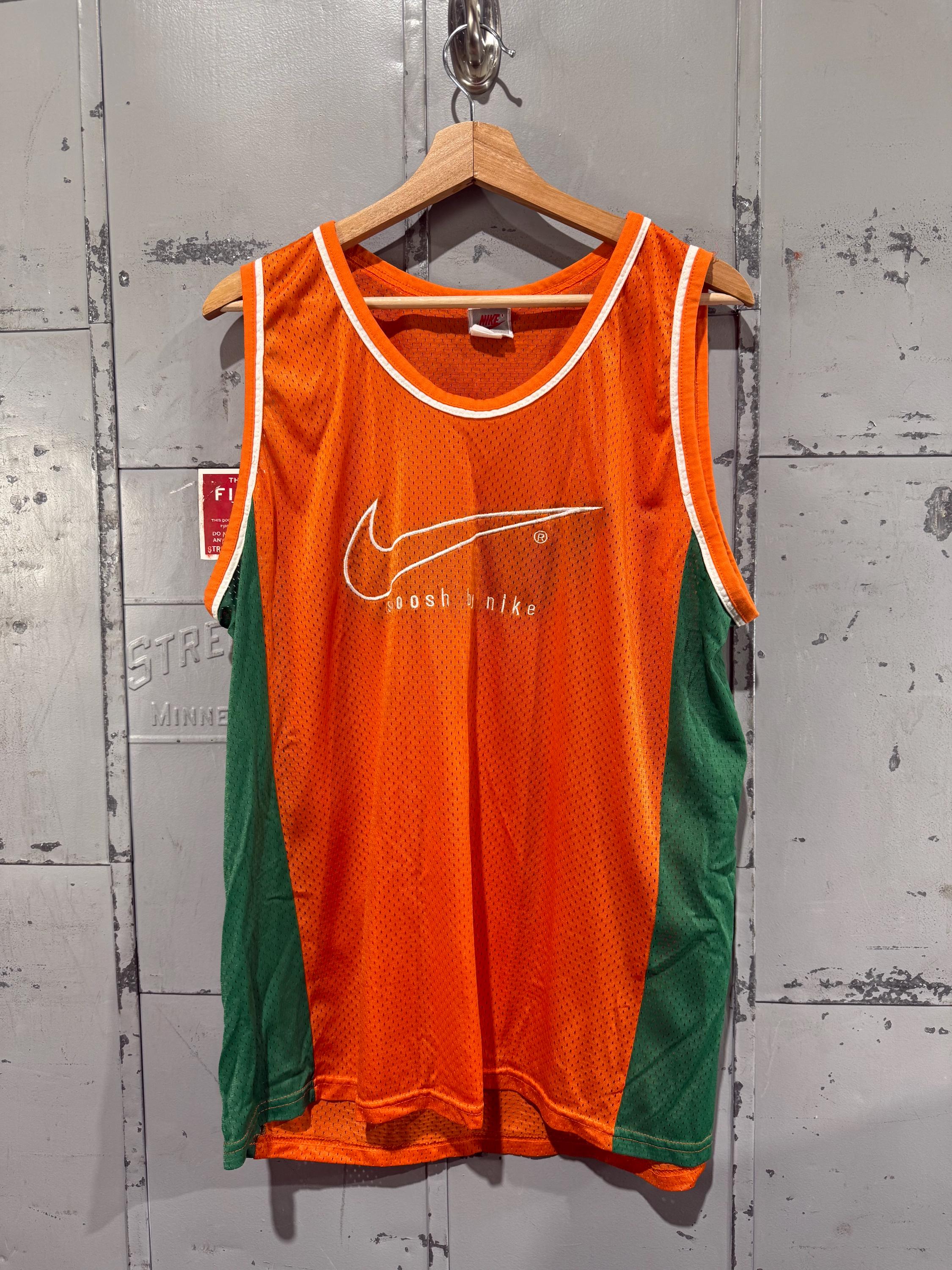 orange and green nike shirt