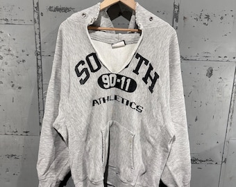 Sudadera con capucha de algodón con estampado gráfico de fútbol americano estilo vintage auténtico de los 90, con tejido inverso desgastado, color avena y gris. Talla L.