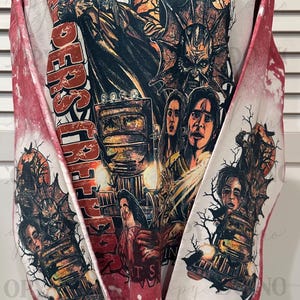 May include: Red and white sweatshirt with a graphic design featuring a horror movie theme. The design includes images of characters, a train, and the words "Riders of the Night". The sleeves have a red and white tie-dye effect.