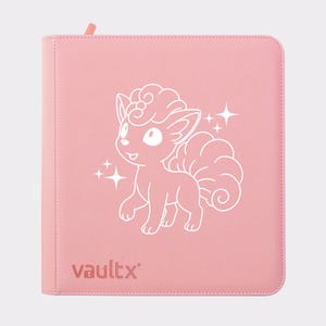 May include: A pink binder with a white illustration of a cartoon fox-like creature and the word "vaultx" in the bottom left corner. The creature has a fluffy tail and is surrounded by sparkling stars.