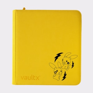 May include: Bright yellow Vault X binder with a zip closure. The binder has a black illustration of two cartoon rabbits with lightning bolts. The Vault X logo is embossed on the lower left.